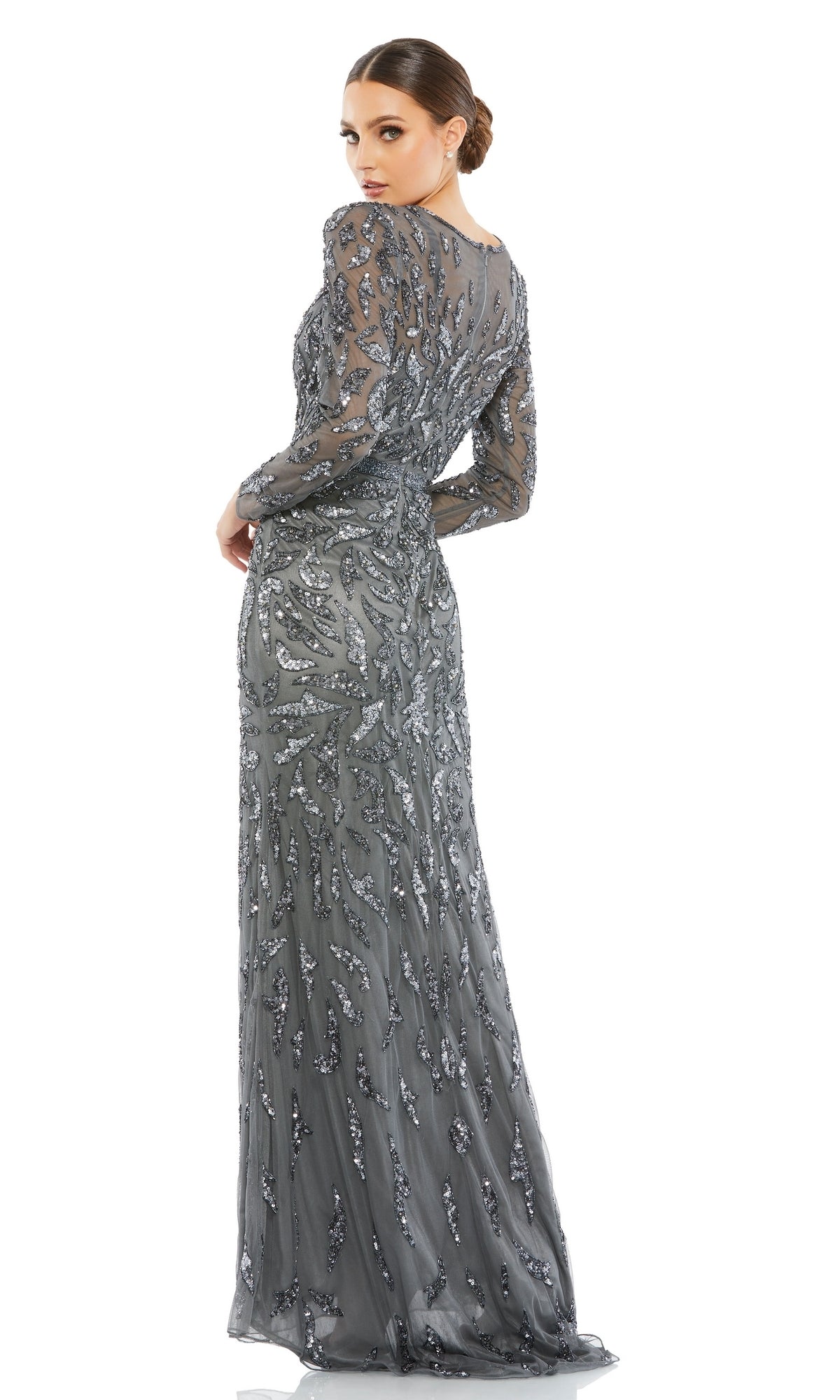 A woman stands against a white background, looking over her shoulder while wearing the Mac Duggal 5124 Long Sleeve Sequin Formal Dress.